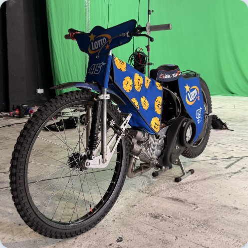 Motocykl żużlowy w barwach LOTTO na planie zdjęciowym.